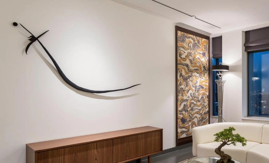 Black three-dimensional wall decoration resembling swords, adding movement and energy.