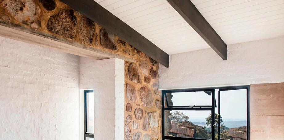 White ceiling with wood accents for elegant Indian-inspired interior.