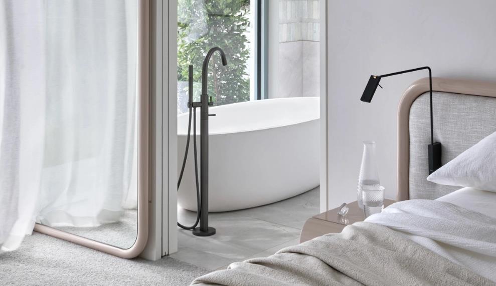 A modern master bedroom with a semi-transparent glass bathroom partition