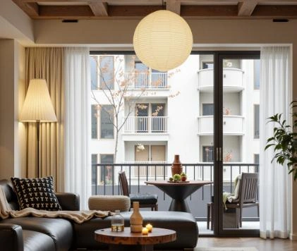 Spherical pendant light with a frosted milky white lampshade