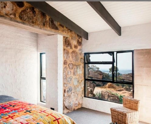 The ceiling of this bedroom features a distinctive design with white lines.
