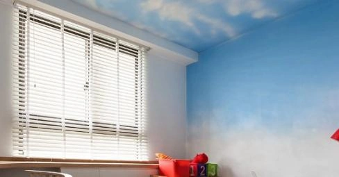 painted murals depicting a blue sky and white clouds